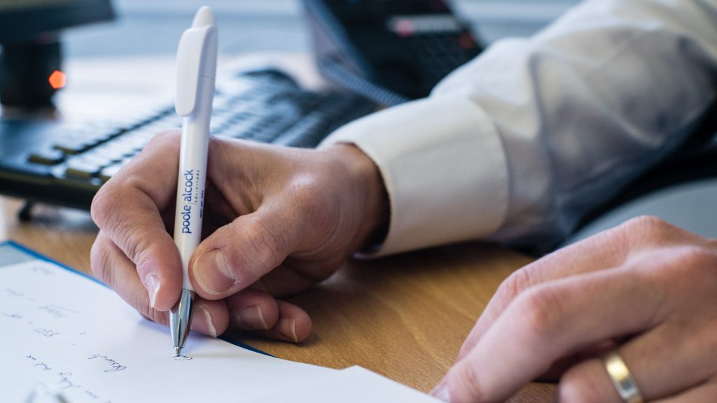 Poole Alcock signing documents
